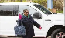  ?? REANN HUBER / REANN.HUBER@AJC.COM ?? Anne Spencer exits an Uber in front of the Dorothy C. Benson Senior Complex in Sandy Springs on Thursday. The complex uses a liaison to schedule rides for seniors.