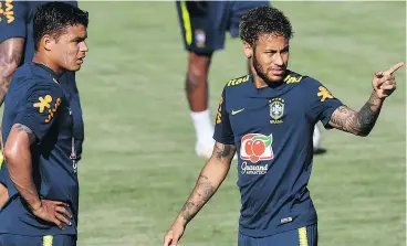  ?? — GETTY IMAGES FILES ?? Brazil’s defensive leader Thiago Silva, left, talks strategy with offensive dynamo Neymar on Thursday during a training session in Sochi, Russia.