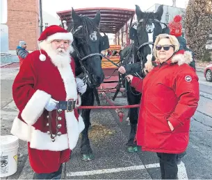  ?? THE CANADIAN PRESS ?? George McKay and his wife Suzanne, a.k.a. Santa and Mrs. Claus, prepare for a horse-drawn wagon ride through downtown Brampton in 2019. Such events are few and far between in 2020.