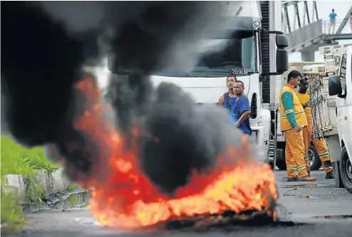  ?? Picture: Reuters ?? Tyres set alight by striking truck drivers in Brazil block a highway near Salvador this week. The drivers are protesting against high diesel prices.