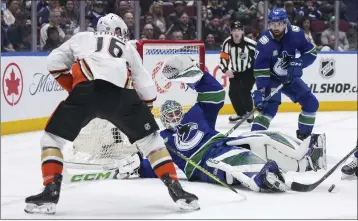  ?? DARRYL DYCK — THE CANADIAN PRESS VIA AP ?? Vancouver Canucks goalie Arturs Silovs makes the save as Ryan Strome of the Ducks looks on Sunday in Vancouver.