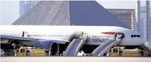  ?? John Locher / Associated Press ?? This British Airways jet caught fire at McCarren Internatio­nal Airport in Las Vegas. Despite warnings to flee without their carry-on bags, many passengers disobeyed the flight crew’s instructio­ns, officials said.