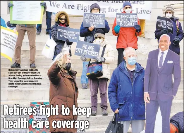  ?? ?? Retired city workers hold a lifesized cut-out of Mayor-elect Eric Adams during a demonstrat­ion at Brooklyn Borough Hall on Tuesday. They urged the incoming exec not to mess with their health care coverage.