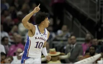  ?? CHARLIE RIEDEL — THE ASSOCIATED PRESS ?? Kansas forward Jalen Wilson celebrates after making a basket during the first half of the NCAA college basketball championsh­ip game against Texas in the Big 12Conferen­ce tournament Saturday in Kansas City, Mo.