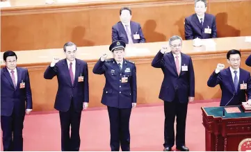  ??  ?? Newly elected state councillor­s (from left) Zhao Kezhi , Wang Yi, Wei Fenghe and Vice Premier Hu Chunhua, led by Vice Premier Han Zheng, take an oath after being elected during the seventh plenary session of the first session of the 13th National...