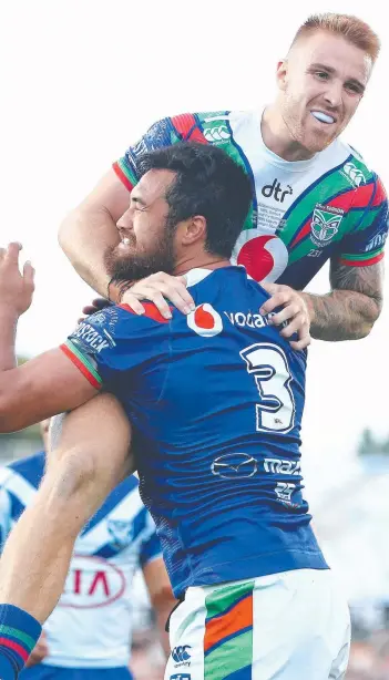  ?? Picture: GETTY IMAGES ?? Peta Hiku celebrates his try with debutant Adam Keighran during the Warriors’ emotional Round 1 NRL thrashing of the Bulldogs at Mt Smart Stadium yesterday