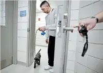 ??  ?? Inmate Justin Martin walks a chocolate lab puppy back into his cell area at Merrimack County Jail in Boscawen, N.H. The New Hampshire jail is the first in the state to partner prisoners with the Hero Pups program to foster and train puppies.