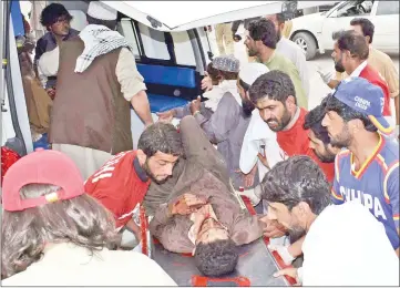  ??  ?? An injured Pakistani man is brought to a hospital in Quetta following a bomb blast at an election rally. — AFP photo