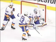  ?? Elsa / Getty Images ?? The game-winning overtime goal by the Flyers’ Philippe Myers (not pictured) gets past Islanders’ goalie Thomas Greiss (1) in Game 2 of their NHL playoff series on Wednesday in Toronto.