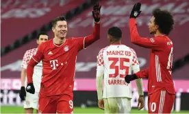  ??  ?? Bayern Munich’s Polish forward Robert Lewandowsk­i celebrates with teammate Leroy Sané during their comeback 5-2 win over Mainz. Photograph: Andreas Gebert/AFP/Getty