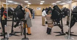  ?? SETH HERALD AFP VIA GETTY IMAGES ?? Ohio residents cast their votes during early voting Tuesday in Toledo.