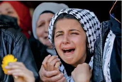  ?? ?? A relative reacts during the funeral of Palestinia­n Amr Alyan, who, according to medics, was killed by Israeli forces during clashes in a raid, in Silwad near Ramallah, in the Israeli-occupied West Bank . (Reuters)