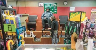  ?? MARY ALTAFFER/AP ?? Bertha Gomez shines shoes Feb. 3 at the Alpha Shoe Repair Corp. in New York. Many shoeshine stands have closed.