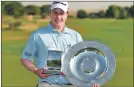  ??  ?? Bob with the Challenge Tour Graduate of the Year trophy and the Henry Cotton European Tour Rookie of the Year shield.