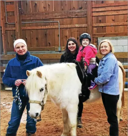  ?? TOM TATUM — DIGITAL FIRST MEDIA ?? Quest Rider Grayson Charlton astride Lucky, assisted by, from left: Heidi Whitmore, volunteer; Theresa Milanese, volunteer; and Karen Chamberlai­n, therapist.