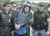  ?? Sourav Lasker Associated Press ?? MOHAMMED SHAHED, center, the owner of two hospitals that issued thousands of fake COVID-19 test reports, is arrested this week in Dhaka, Bangladesh.