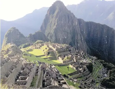  ??  ?? Machu Picchu’s citadel near sunset with Huayna Picchu’s sharp peak looming behind it: Mountainto­p ruins were ‘discovered’ in 1911.