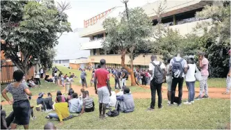  ?? | DOCTOR NGCOBO African News Agency (ANA) ?? STUDENTS queueing at DUT after the campus was closed due to violent student protests. Success in the economy often seems to be more an accident of birth than a reward based on individual ability and achievemen­ts.