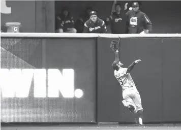  ?? Jeff Roberson/Associated Press ?? ■ Los Angeles Dodgers center fielder Chris Taylor (3) catches the fly ball hit by Milwaukee Brewers’ Christian Yelich during the fifth inning of Game 7 of the National League Championsh­ip Series on Saturday in Milwaukee.