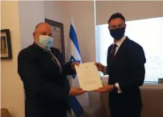  ?? ( Protocol Dept. MFA) ?? AUSTRALIA’S NEW ambassador to Israel, Paul Griffiths ( right), presents his credential­s to the Foreign Ministry’s Chief of Protocol Meron Reuben.