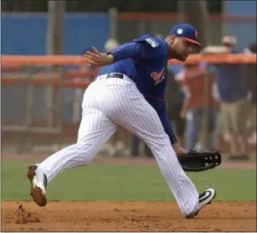  ?? DAVID J. PHILLIP — THE ASSOCIATED PRESS ?? New York Mets first baseman Lucas Duda fields a ground ball during a spring training baseball workout Tuesday in Port St. Lucie, Fla. Duda resumed full baseball activities after being slowed by back and hip issues.