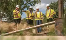  ?? Mark Mulligan / Staff photograph­er ?? FCC Commission­er Brendan Carr, second from right, tours a Second Ward site for fiber that will support a 5G network.