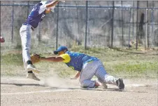  ?? ?? In Game 1 action of their doublehead­er with Santa Rosa on Friday (April 8), Peñasco Panther Third Baseman Elijah Lucero applies the tag to Santa Rosa’s Nicholas Chavez after a rifle throw from Catcher Zack Gonzales for a classic pick-off play.