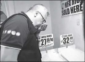  ?? EDD GUMBAN ?? Trade and Industry Secretary Ramon Lopez monitors rice prices at the Paco Market in Manila yesterday.