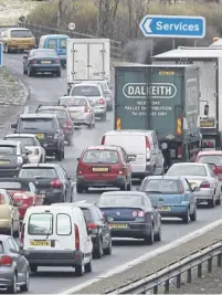  ?? ?? Main: A big pothole is pictured on a main road in Glasgow. A Glasgow City Council spokespers­on said it had doubled road maintenanc­e spending to £12. The M8, above, is Scotland’s busiest road. Stephen Kerr, right, wants action.