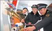  ?? LI XIN / FOR CHINA DAILY ?? Inspectors check the quality of heating devices in Huaibei, Anhui province, in December.