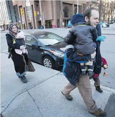  ?? WAYNE CUDDINGTON ?? Caitlan Coleman, seen walking with husband, Joshua Boyle, and their three children in downtown Ottawa, has alleged that Joshua abused her during their five years in captivity with a Taliban-linked group in Pakistan and Afghanista­n.