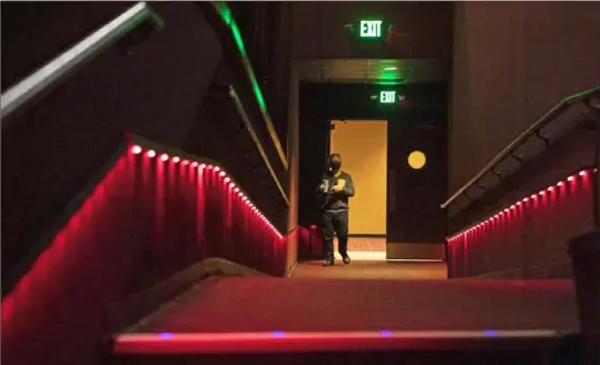  ?? Emily Matthews/Post-Gazette ?? A person enters an auditorium to watch “Tom and Jerry” during a family, friends and media night Wednesday at GQT Movies Pittsburgh Mills in Frazer. The new theater replaced Cinemark 18 at the Galleria at Pittsburgh Mills.