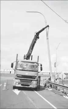  ?? ?? A light pole being installed on Sheriff Street