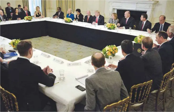  ??  ?? WASHINGTON: US President Donald Trump holds a policy and strategy forum with top business executives in the State Dining Room of the White House yesterday. —AFP