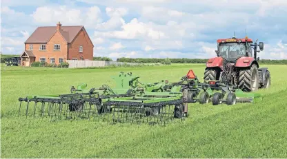  ?? ?? The trailed harrow with five rows of flexible tines is a complement­ary implement that can be used alone or behind the mower.