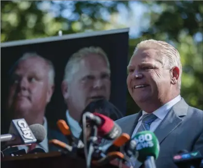  ?? CHRISTOPHE­R KATSAROV, THE CANADIAN PRESS ?? Former Toronto city councillor Doug Ford announces he is publishing a book: "Ford Nation, Two Brothers, One Vision: The True Story of the People’s Mayor," at a news conference in Toronto last year. Ford says he will be running for mayor in the 2018...