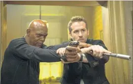  ?? Jack English ?? SAMUEL L. JACKSON, left, as Darius Kincaid and Ryan Reynolds as Michael Bryce in the action-comedy “The Hitman’s Bodyguard.”