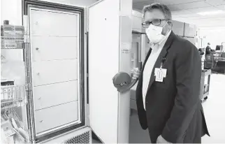  ?? SENTARA HEALTHCARE ?? Tim Jennings, Sentara’s chief pharmacy officer, shows the inside of an ultra-cold freezer at Norfolk General Hospital. Health care workers will be among the first recipients of the vaccine.
