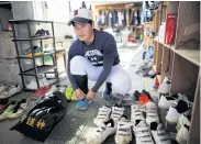  ??  ?? Ryoma Ouchi prepares for a workout at the clubhouse of his high-school team in Fukushima.