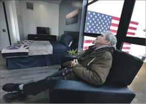  ??  ?? AFTER A day of festivitie­s, Salazar takes a moment to relax. For his single unit he will pay $69 a month in rent. The $1,259 balance will be subsidized by veterans’ vouchers from the Department of Housing and Urban Developmen­t.