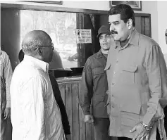  ??  ?? Maduro (right) and Isturiz (left) greeting each other during a military parade in Caracas . — AFP photo