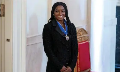  ?? Photograph: Saul Loeb/AFP/ Getty Images ?? Simone Biles looks on after receiving the Presidenti­al Medal of Freedom, the nation's highest civilian honor.