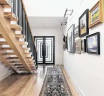  ??  ?? Doors, windows and a stair rail feature a Prairie-style linear design.