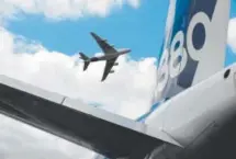  ?? Photos by Eric Piermont, AFP/Getty ?? An Airbus A380 performs a flying display over another A380 at Le Bourget airport, near Paris, on June 24 during the Internatio­nal Paris Air Show.