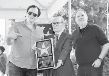  ??  ?? Director Tarantino (left) and producer Weinstein (right) attend Italian composer Ennio Morricone’s star unveiling ceremony on the Hollywood Walk of Fame in Hollywood, California on Feb 26, 2016. — Reuters file photo