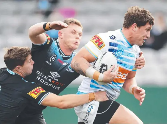  ?? Picture: GETTY IMAGES ?? Jarrod Wallace of the Titans heads for the tryline to score during the Round 14 clash with Cronulla Sharks at the weekend.