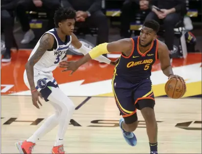  ?? JANE TYSKA — BAY AREA NEWS GROUP ?? The Warriors’ Kevon Looney (5) is guarded by the Timberwolv­es’ Jaden McDaniels during the second quarter at the Chase Center in San Francisco on Monday.