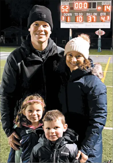  ?? VERDE FAMILY PHOTO ?? Coach Jerry Verde celebrates Evergreen Park’s Class 5A victory Saturday over Elmwood Park with his wife, Angie, and children.