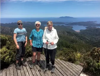  ??  ?? Above left: Stopping for photos at Windy Canyon.
Below left: At the sunmit with Port Fitzroy and Little Barrier Island in the background.