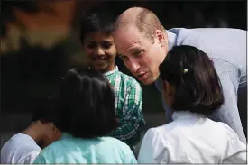  ??  ?? ‘AMAZING’: William meets youngsters while playing cricket